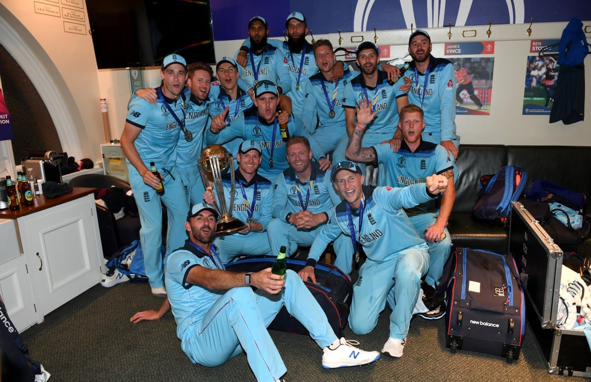 England team pose for a photo with the trophy in the dressing room