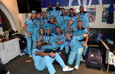 England team pose for a photo with the trophy in the dressing room