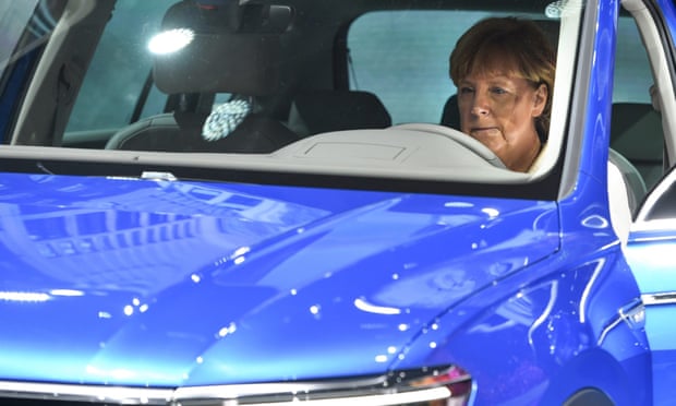 Angela Merkel sits in a Volkswagen Tiguan at the International Motor Show in Frankfurt