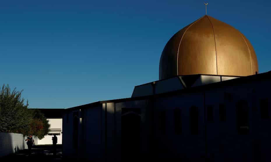Armed police officers stand guard outside Al Noor mosque following the Christchurch massacre