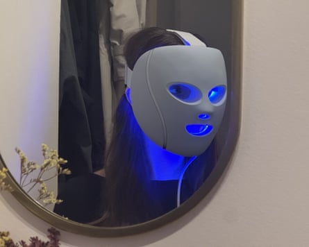 The writer wearing a blue-glowing Shark CryoGlow seen in a mirror