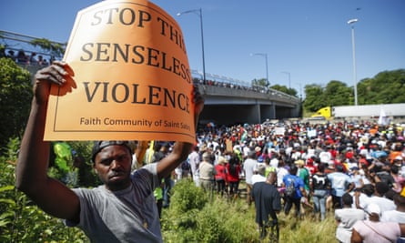 An activist holds a sign during march along Chicago Dan Ryan Expressway on Saturday