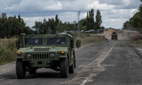 Ukrainian servicemen ride military vehicles from a crossing point with Russia, amid Russia's attack on Ukraine, at the border in Sumy region, Ukraine August 13, 2024.