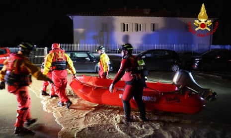 Italian firefighters work to evacuate people from flooded houses in Campi Bisenzio, near Florence, after Storm Ciarán hit Tuscany late on 2 November 2023.