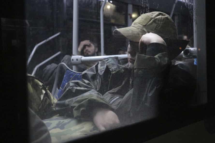 Ukrainian servicemen sit in a bus after leaving Mariupol’s besieged Azovstal steel plant.