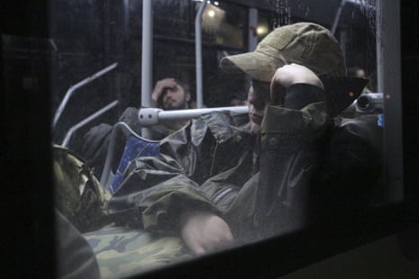 Ukrainian servicemen sit in a bus after leaving Mariupol’s besieged Azovstal steel plant.