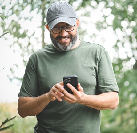 Man walking in the park with a mobile phone