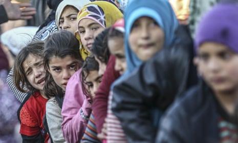 A queue of children wait at the Turkey-Syria border