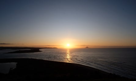 sun rising over the sea in new zealand