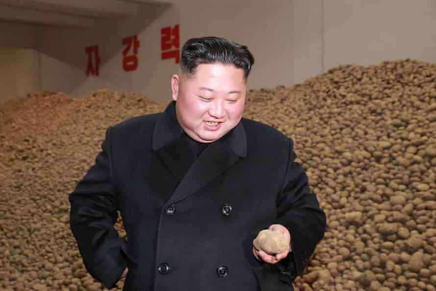 Kim inspects potatoes at a factory in Samjiyon county.