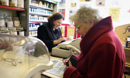 Elderly woman and shopkeeper