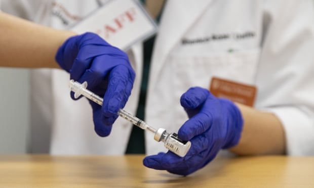 Pharmacy student prepares Pfizer vaccine to be given.
