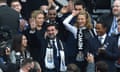 Newcastle's chairman Yasir al-Rumayyan waves to fans next to their minority owner Amanda Staveley (right)