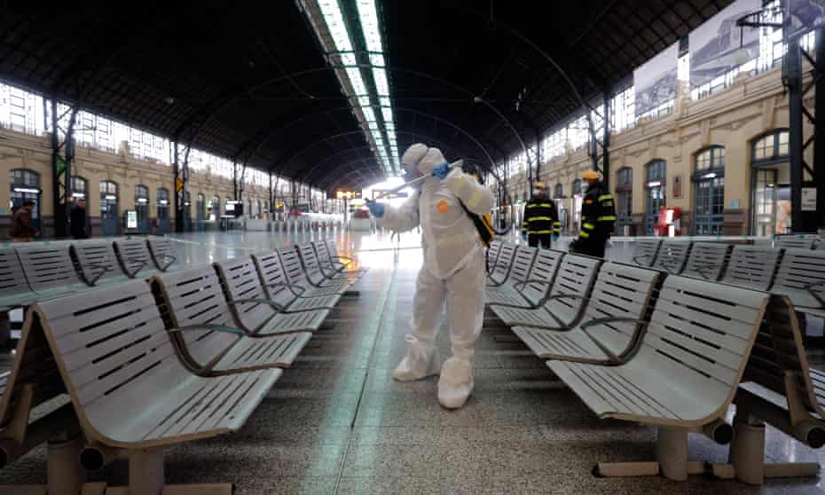 A Spanish soldier disinfects a railway station in Valencia on Monday after the government placed the country in lockdown on Saturday.
