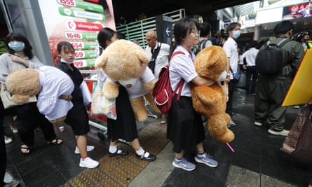 Secondary school students hold giant teddy bears as they attend a Bad Student rally in Bangkok on Saturday.