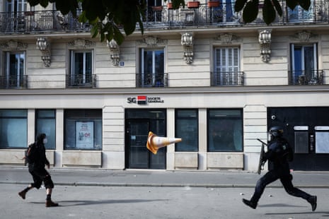 A protester throws a traffic cone at a member of French Republican Security Corps during a demonstration of high-school students, in Paris.