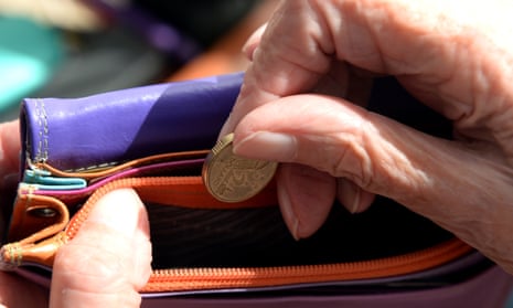 An Australian dollar coin is taken out of a purse. Canberra, 8 April 2014. 
