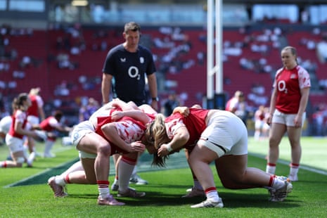 Sarah Bern and Kelsey Clifford warm up with some of their England teammates.