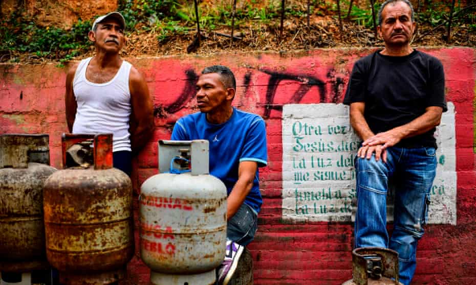 Locals line up to replace empty propane gas drums in Las Minas de Baruta neighborhood, Caracas, on Thursday.
