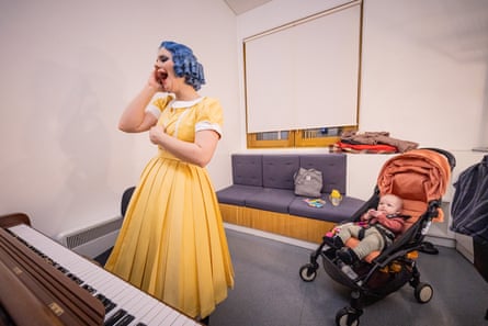 Olga Pudova does vocal excerices whilst her baby watches on, inside her dressing room at the Royal Opera House, before appearing as Olympia in The Tales of Hoffman.