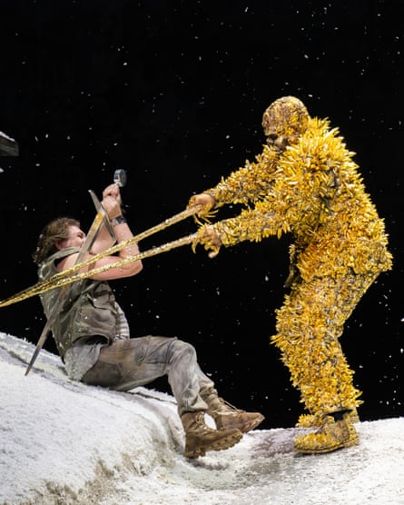 Two performers – one dressed head to toe in a gold-coloured outfit – battle in a scene from the Royal Opera’s new production of Siegfried.