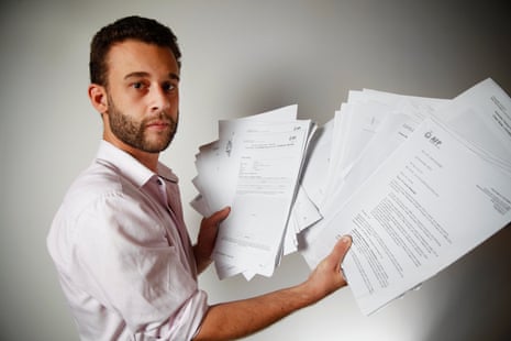 Guardian Australia journalist Paul Farrell displays his police files compiled by Australian federal police