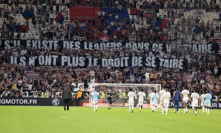 Lyon supporters hold up a banner in French, saying: “If there are leaders in the locker room, they no longer have the right to be silent.”