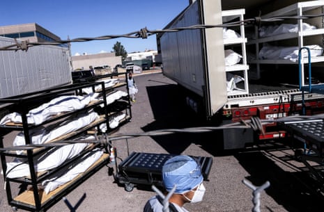 An inmate from El Paso county detention facility prepares to load bodies into a refrigerated temporary morgue in Texas on 16 November. 