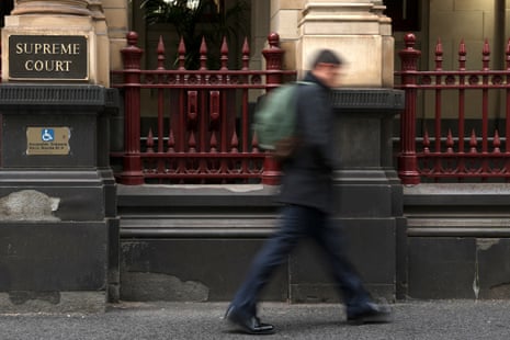Person walks past supreme court in Melbourne