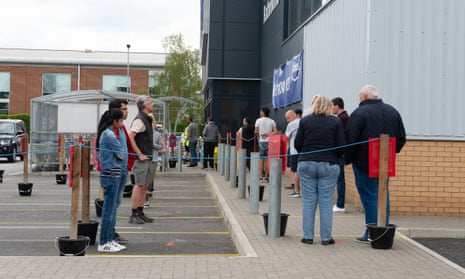 Shoppers queue outside a Wickes DIY stores in Staines-upon-Thames, Surrey