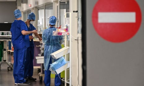 Nurses stand in a corridor at the intensive care unit for Covid-19 patients 