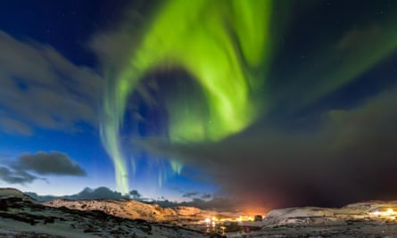 Northern lights over snow-capped mountains in Murmansk