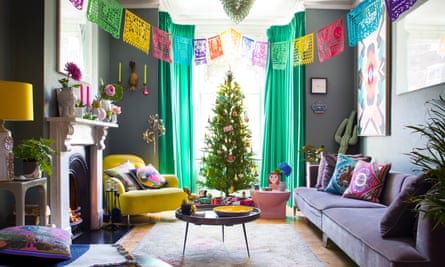 Day of the Dead flags and Christmas decorations, including a large Christmas tree in the window, in the sitting room.