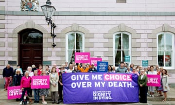 People take part in a Dignity in Dying protest outside the states assembly building during a debate on assisted dying