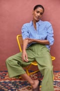 A model wearing green linen trousers and a striped shirt from Wyse London