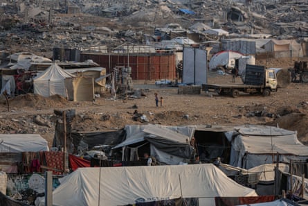people walk between tents