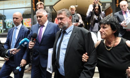 Greg (centre) and Virginia Hughes, the parents of cricketer Phillip Hughes, leave the Downing Centre Court in Sydney, Friday, 14 October.