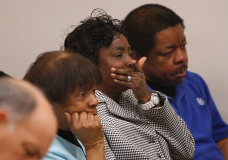 Shirley Burns, center, mother of Marcus Robinson, listens in court.