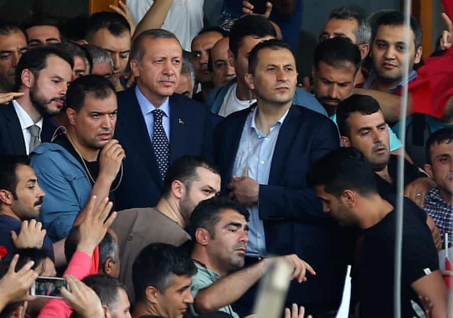 President Erdoğan surrounded by security and supporters as he arrives at Atatürk airport in Istanbul.