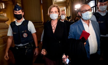 Delphine Boël surrounded by her lawyer and a policeman.