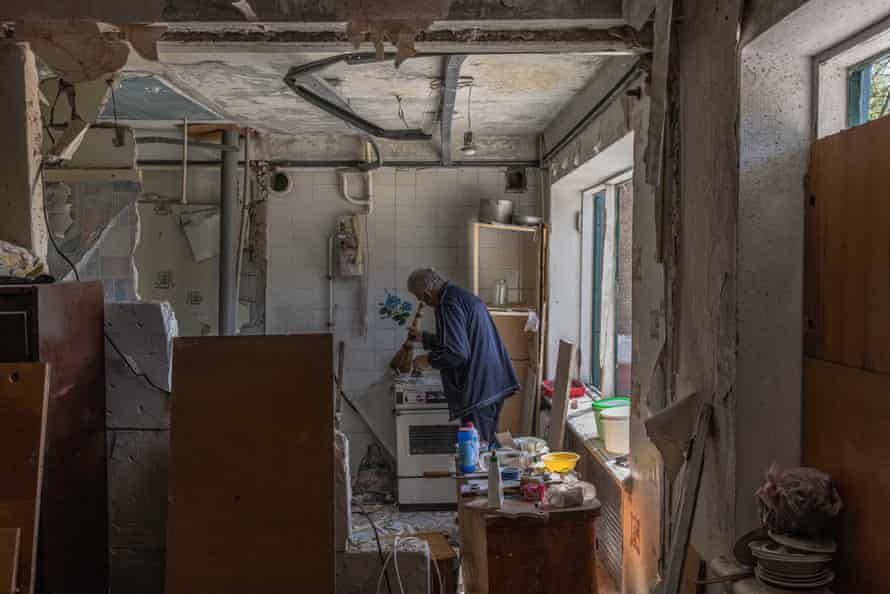 A man cleans an apartment in a damaged building after the recent Russian airstrike, in Kramatorsk, Donetsk region, eastern Ukraine.