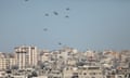 Humanitarian aid packages dropped from the air by Jordanian, US, Egyptian and French army planes are seen floating on the sky in Gaza City.