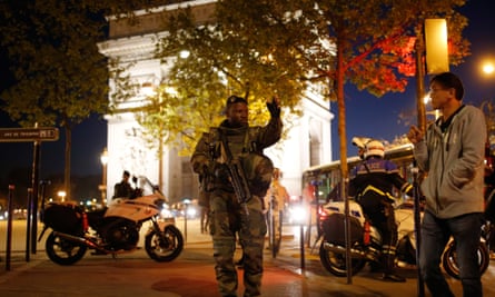An armed soldier secures a side road near the Champs Elysees after the incident