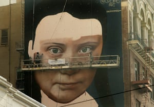 A mural on the side of a building depicts the Swedish teen climate activist Greta Thunberg.