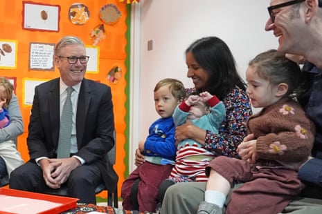 Keir Starmer (left) speaks with parents and children during his visit to a nursery in central London today, ahead of his speech on the budget.