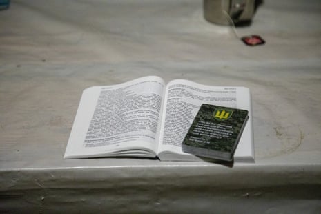 A Bible is seen on a table during as a member of clergy meets with Ukrainian soldiers in the barracks in the Nykyforivka village of Donetsk.