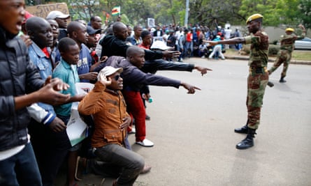Soldiers stop people as they try to make their way to State House.