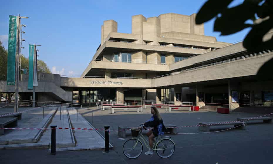 A cyclist rides past the National Theatre in London in April with its forecourt taped off to prevent use during lockdown.
