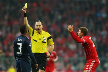 Jonas Eriksson books Manchester United’s Patrice Evra.