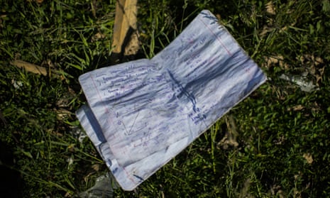 A notebook lies on the ground next to a school destroyed in Russian bombing in Bakhmut, eastern Ukraine.